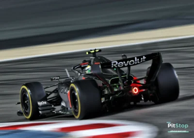 Vue arrière de la monoplace Audi F1 en action lors des essais de nuit à Bahreïn, mettant en avant l'aileron arrière sponsorisé par Revolut.